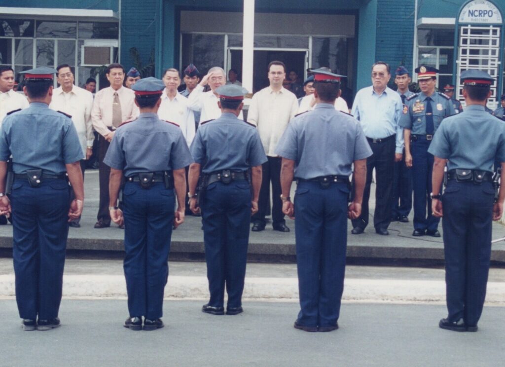Alan Peter Cayetano attends a police ceremony, possibly an inspection or honor guard event, showing support for law enforcement.