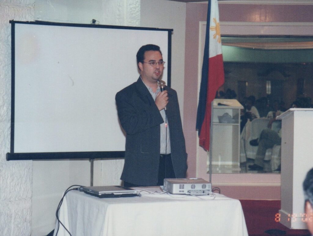 Alan Peter Cayetano delivers a presentation or speech at an event, likely discussing policy or governance topics.