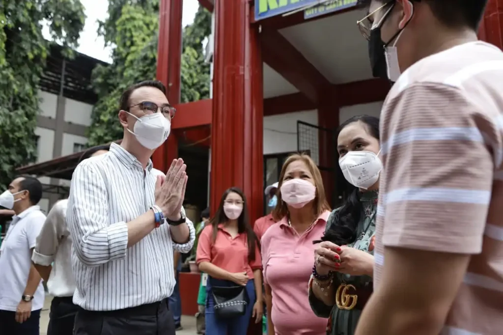 Former House Speaker Alan Peter Cayetano is greeted by local government officials in Sta. Rosa, Laguna before the donation drive commenced.