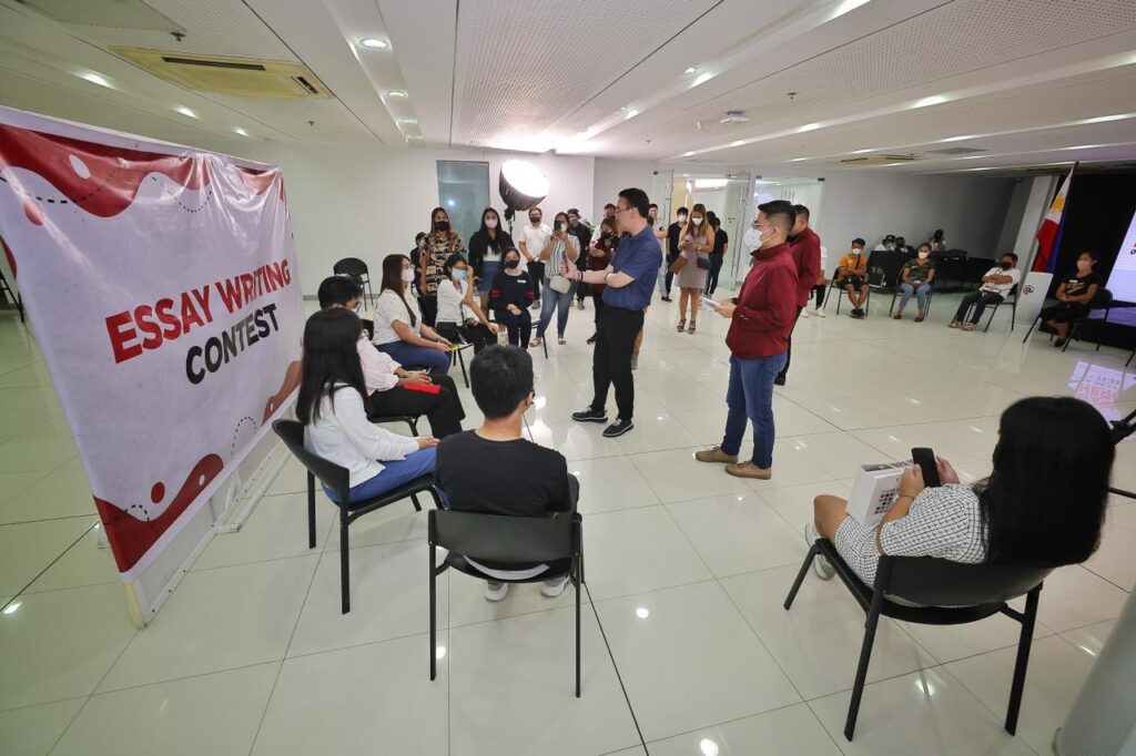 Alan Peter Cayetano hosts an Essay Writing Contest, engaging with masked participants, promoting education, and encouraging youth involvement in literacy.