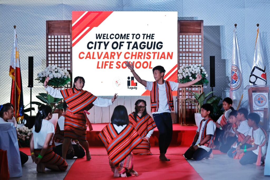 Students perform a cultural dance at the City of Taguig Calvary Christian Life School welcome event, showcasing local traditions.